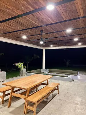 a wooden table and benches in a patio at Finca Luxury en Doradal Antioquia in Puerto Triunfo