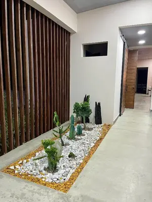 a living room with plants on the floor at Finca Luxury en Doradal Antioquia in Puerto Triunfo