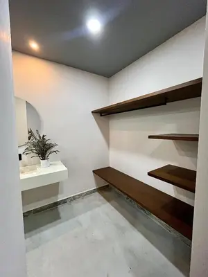 a room with white walls and wooden shelves at Finca Luxury en Doradal Antioquia in Puerto Triunfo