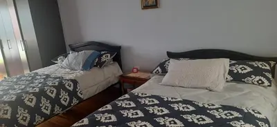 two beds sitting next to each other in a bedroom at Casa para ferias manizales in Manizales