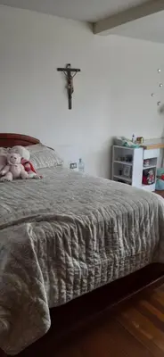 a bedroom with a bed with a cross on the wall at Casa para ferias manizales in Manizales
