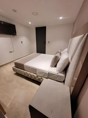 a bedroom with a bed and a table in it at Hotel Med 33 in Medellín