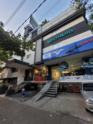 a store with a car parked in front of it at Hotel Med 33 in Medellín