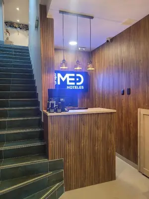 a new hotel lobby with stairs and a ned hotel sign at Hotel Med 33 in Medellín