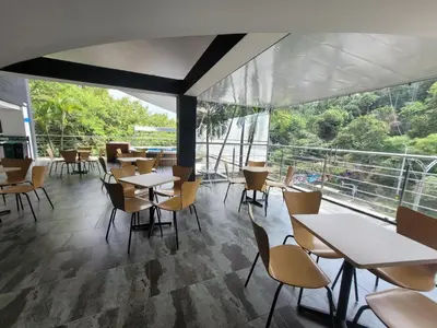 a restaurant with tables and chairs and a large window at Hotel Med 33 in Medellín