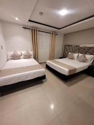 two beds in a room with two beds sidx sidx sidx sidx at Hotel Med 33 in Medellín