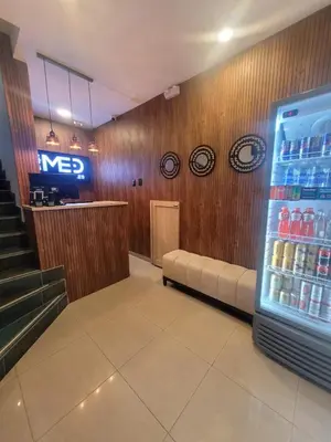 a waiting room with a refridgerator and a drink refrigerator at Hotel Med 33 in Medellín