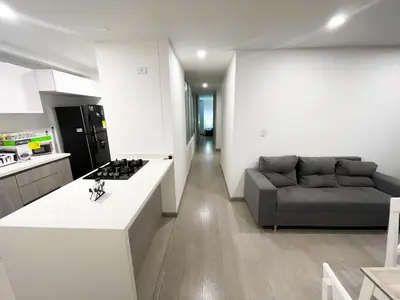 a kitchen and living room with a couch and a stove at Maravillosas vistas, excelente ubicación in Manizales