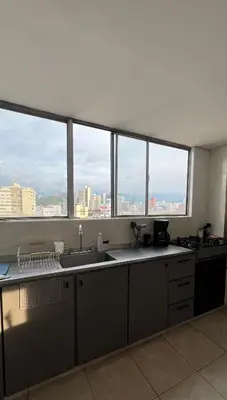 a kitchen with a view of a city skyline at Apartamento Vista Panoramica 3 habitaciones 2 baños - Av Santander Sector El Cable y Estadio Palogrande in Manizales