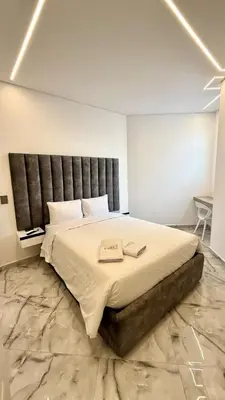 a bedroom with a large bed with a black headboard at Foret Lofts in Medellín
