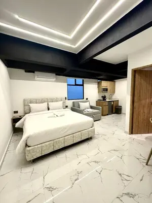 a bedroom with a large bed and a living room at Foret Lofts in Medellín