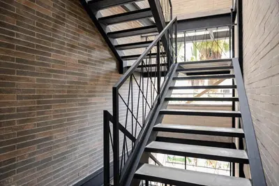a staircase leading up to a brick wall at Foret Lofts in Medellín