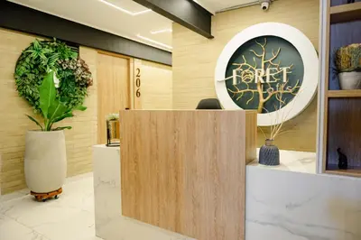 a lobby with a forest office sign on the wall at Foret Lofts in Medellín