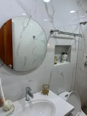 a white bathroom with a sink and a mirror at Paco House in Jardin