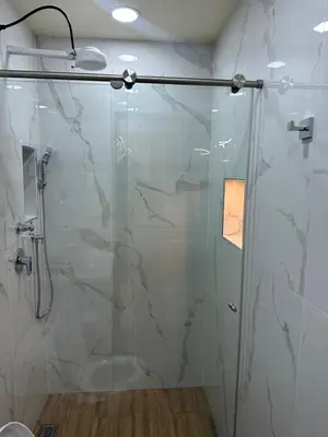a bathroom with a shower with a glass door at Paco House in Jardin