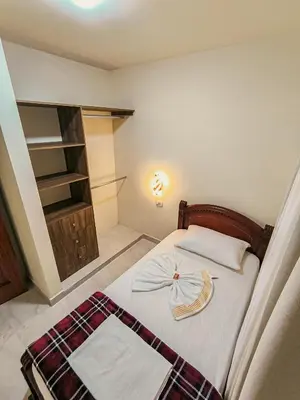 a bedroom with a bed with a bow on it at Paco House in Jardin