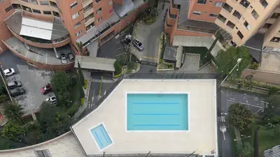 an overhead view of a swimming pool in a city at 3BR Stunning 19th Floor Views Pool Sabaneta in Sabaneta