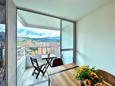 an apartment with a balcony with a table and chairs at 3BR Stunning 19th Floor Views Pool Sabaneta in Sabaneta