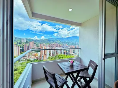 a balcony with a table and chairs and a view at 3BR Stunning 19th Floor Views Pool Sabaneta in Sabaneta