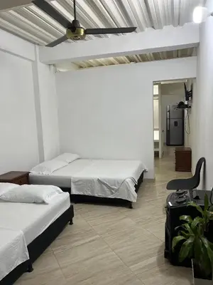 a bedroom with two beds and a ceiling fan at Apartamento Nápoles in Doradal