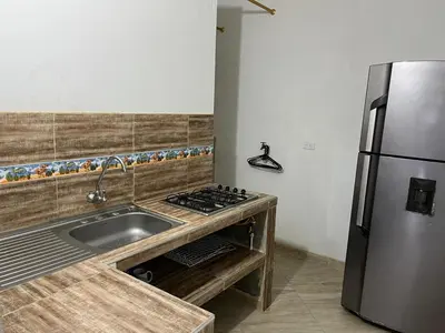 a kitchen with a sink and a stainless steel refrigerator at Apartamento Nápoles in Doradal