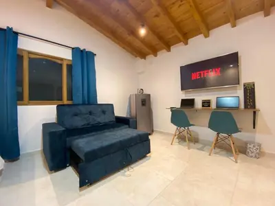 a living room with a couch and a desk at Fraternity Room, Habitación Deluxe - solo a una cuadra del parque in Carmen de Viboral