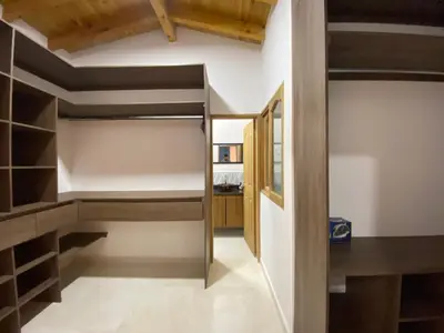 a room with a closet with wooden shelves at Casa Dorada - Confort a solo una cuadra del Parque in Carmen de Viboral