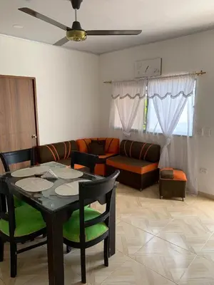 a living room with a table and a couch at Apt vacacional 301 in Doradal