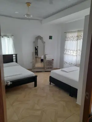 a bedroom with two beds and a mirror at Apt vacacional 301 in Doradal