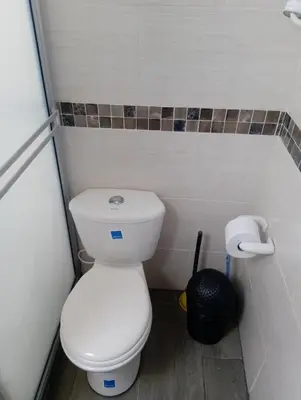 a small bathroom with a toilet and a trash can at Apt vacacional 301 in Doradal