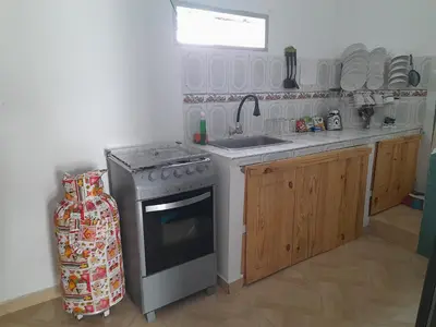 a small kitchen with a stove and a sink at Apt vacacional 301 in Doradal
