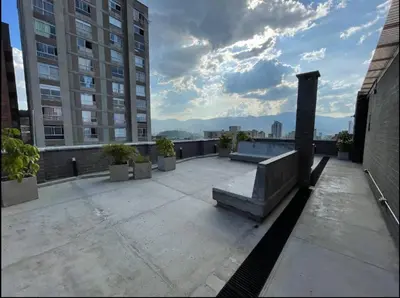 a balcony with a bench on top of a building at Encantador Loft urbano en el corazón de Medellín in Medellín