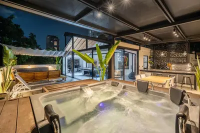 a jacuzzi tub in the middle of a patio at Luxury Retreat Private Sauna, Jacuzzi, Pool table, Games, Very Large 5 Bedrooms Complete Apartment in Medellín