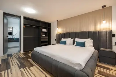 a bedroom with a large bed with a large white bedspread at Luxury Retreat Private Sauna, Jacuzzi, Pool table, Games, Very Large 5 Bedrooms Complete Apartment in Medellín