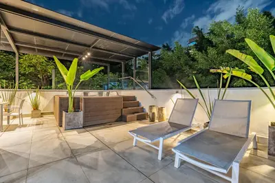 a patio with two chairs and a bench at Luxury Retreat Private Sauna, Jacuzzi, Pool table, Games, Very Large 5 Bedrooms Complete Apartment in Medellín