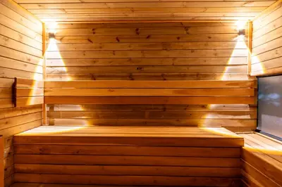 a sauna with a bench in the middle at Luxury Retreat Private Sauna, Jacuzzi, Pool table, Games, Very Large 5 Bedrooms Complete Apartment in Medellín