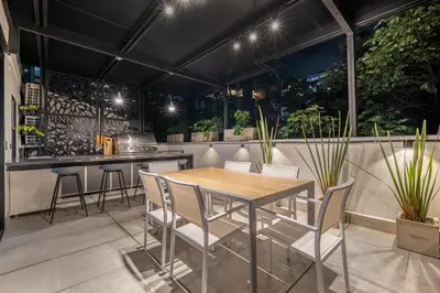 a table and chairs in a kitchen with plants at Luxury Retreat Private Sauna, Jacuzzi, Pool table, Games, Very Large 5 Bedrooms Complete Apartment in Medellín