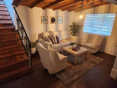 a living room with a couch and chairs and a table at Finca en el corazón de llanogrande in Rionegro