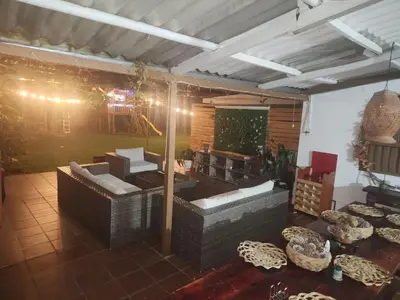 a living room with a couch and a table at Finca en el corazón de llanogrande in Rionegro