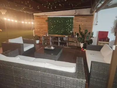 a living room with couches and a large screen at Finca en el corazón de llanogrande in Rionegro