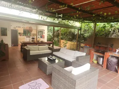 an outdoor living room with couches and a table at Finca en el corazón de llanogrande in Rionegro