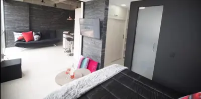 a living room with a couch and a table at EXCLUSIVO APARTAMENTO para disfrutar Medellin in Medellín