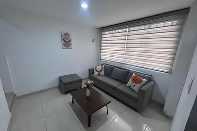 a living room with a couch and a table at Casa Amplia y Cómoda - Estrato 5 in Manizales