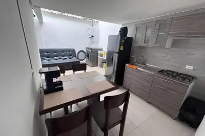 a kitchen with a table and chairs in a kitchen at Casa Amplia y Cómoda - Estrato 5 in Manizales