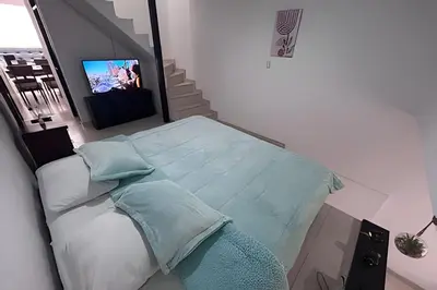 a bedroom with a bed with a television in it at Casa Amplia y Cómoda - Estrato 5 in Manizales