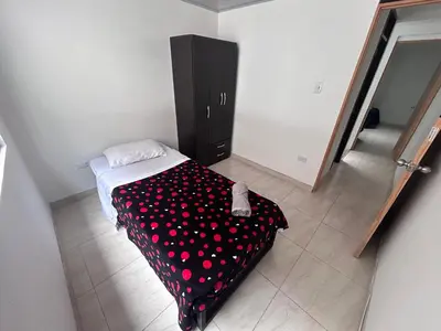 a bedroom with a bed with polka dot sheets at Casa Amplia y Cómoda - Estrato 5 in Manizales