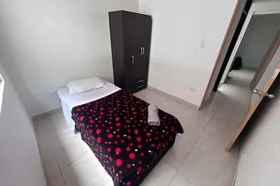 a bedroom with a bed with red polka dots at Casa Amplia y Cómoda - Estrato 5 in Manizales