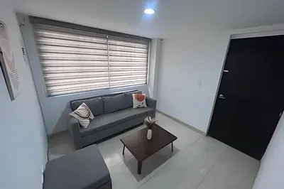 a small living room with a couch and a table at Casa Amplia y Cómoda - Estrato 5 in Manizales
