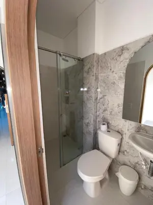 a bathroom with a toilet and a shower and a sink at Habitaciones en Doradal 205 in Doradal