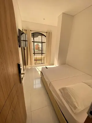 a small bedroom with a bed and a window at Habitaciones en Doradal 205 in Doradal